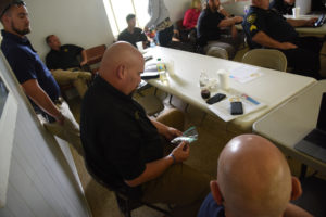 Image of Law Enforcement inspecting training samples of industrial hemp